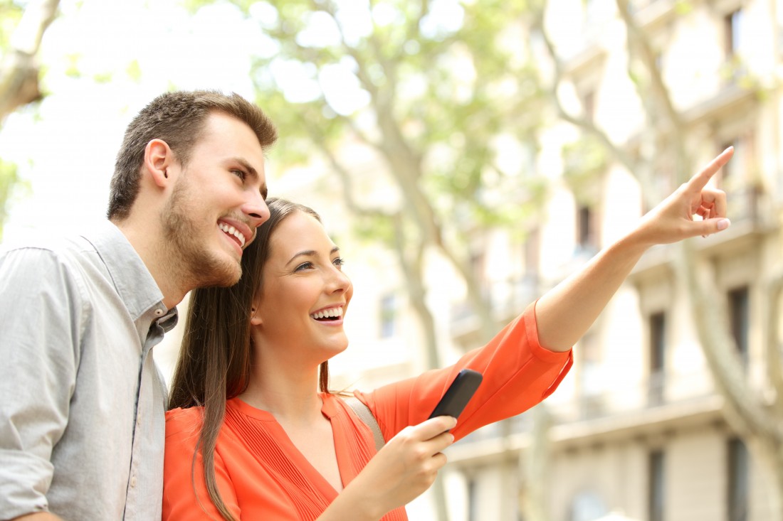 Happy couple exploring a new neighborhood, representing M2 Property Group's apartment and townhome communities